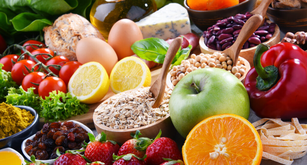 Assorted fresh organic foods and vegetables on a table for healthy eating