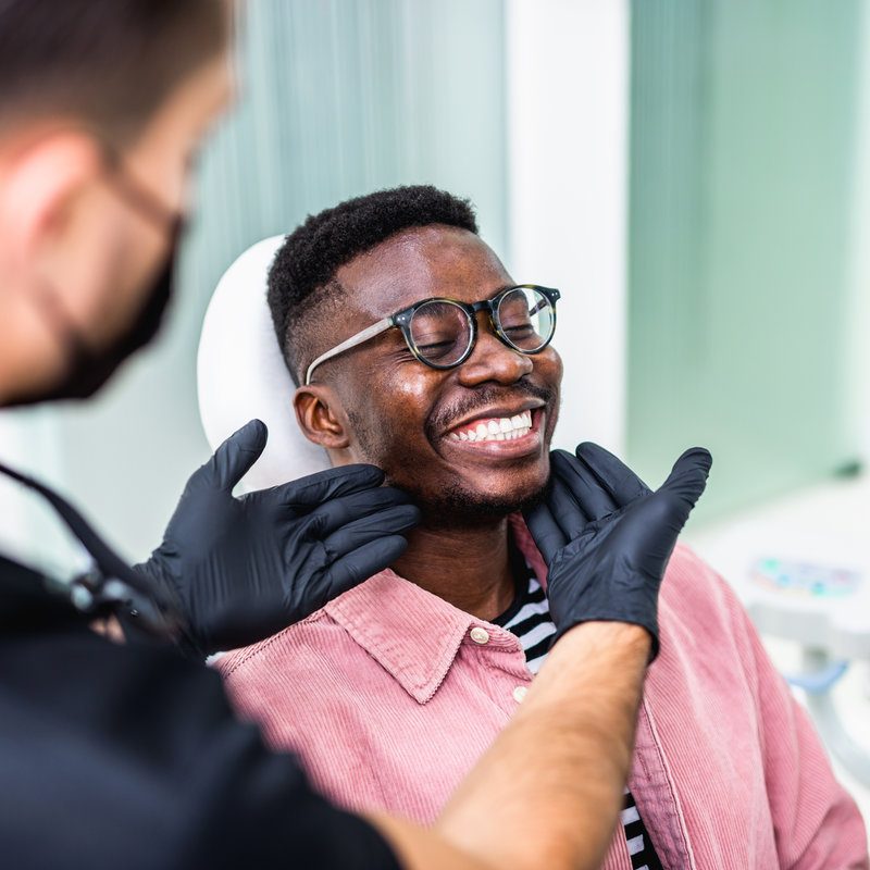 African american young man having a visit at the dentist's. He is sitting on chair at dentist office in dental clinic.