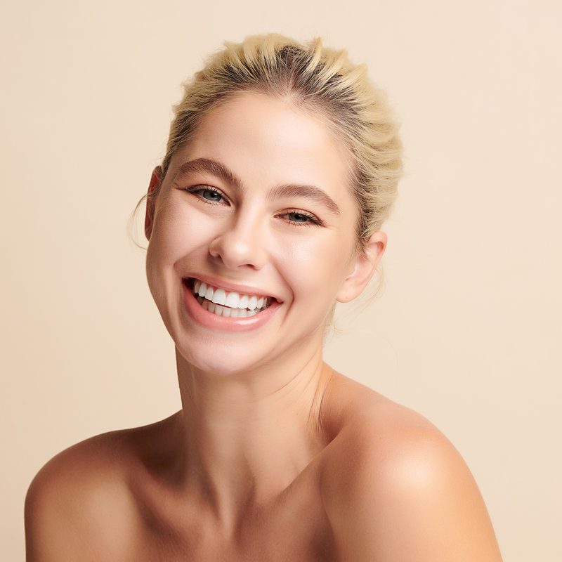 Beautiful smile young woman. White teeth on white background,