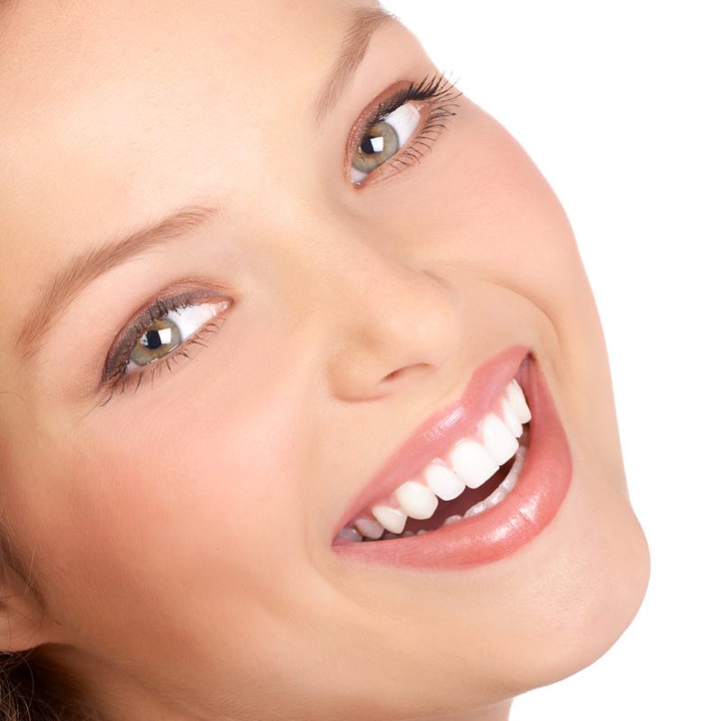 Beautiful young woman smiling. Isolated over white background.