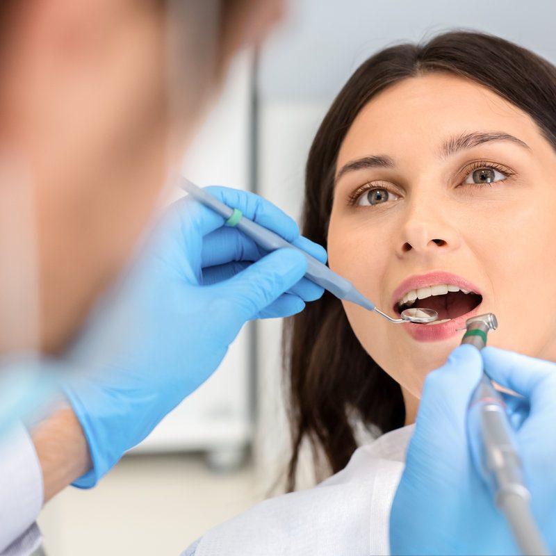 Close up of female patient during treatment at dentist