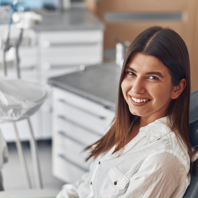 Happy caucasian woman at dentist cabinet