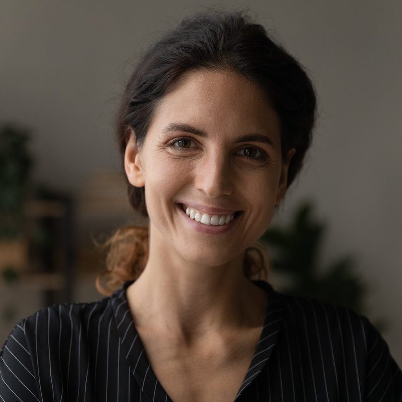 Head shot portrait of pleasant attractive millennial caucasian hispanic latina woman renter posing in modern renovated apartment. Profile picture of happy young female homeowner in new dwelling.
