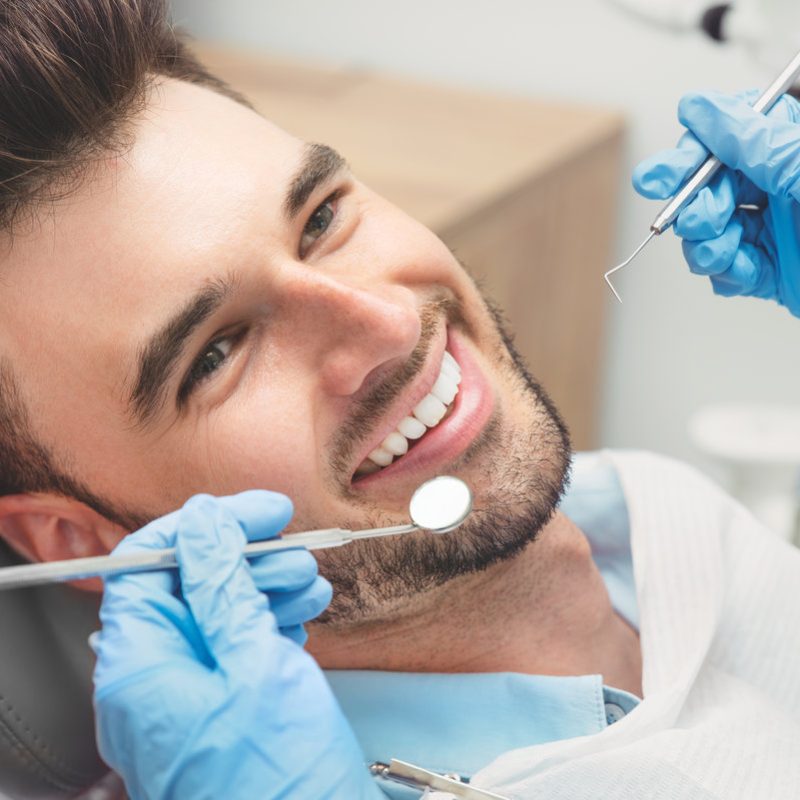 Man having teeth examined at dentists